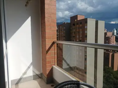a balcony with a view of a city at El Poblado, Medellín con Piscina, gym, cómodo, linda vista. in Medellín