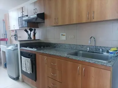 a kitchen with a sink and a stove at El Poblado, Medellín con Piscina, gym, cómodo, linda vista. in Medellín