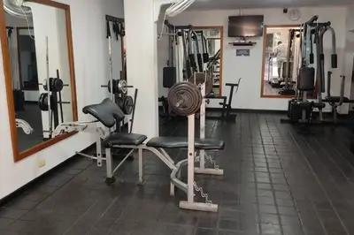 a gym with a lot of equipment in a room at El Poblado, Medellín con Piscina, gym, cómodo, linda vista. in Medellín