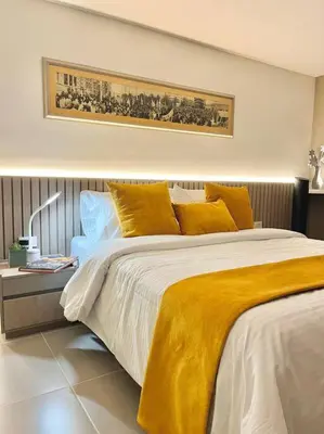 a bedroom with a large bed with yellow pillows at Luxury El Poblado Loft, relax in Medellin's heart! in Medellín