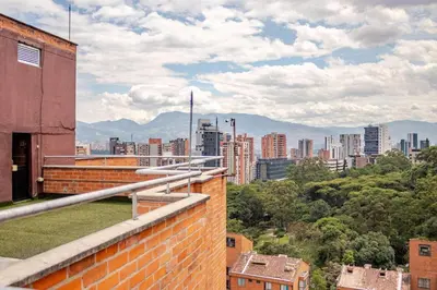 a view of the city from the rooftop of a building at Luxury El Poblado Loft, relax in Medellin's heart! in Medellín