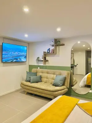 a living room with a couch and a tv at Luxury El Poblado Loft, relax in Medellin's heart! in Medellín