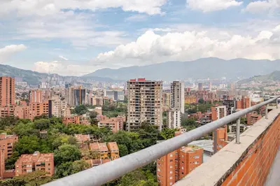 a view of a city with buildings and mountains at Luxury El Poblado Loft, relax in Medellin's heart! in Medellín