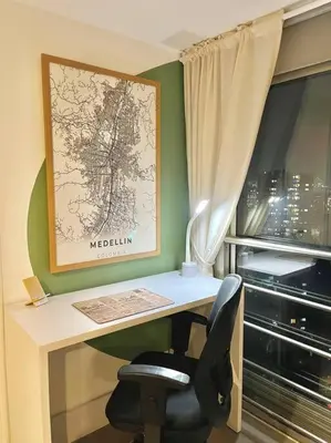 a desk with a chair and a map on the wall at Luxury El Poblado Loft, relax in Medellin's heart! in Medellín