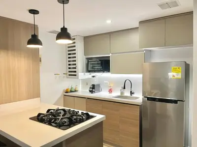 a kitchen with a stove and a refrigerator at Luxury El Poblado Loft, relax in Medellin's heart! in Medellín
