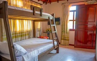 a bedroom with two bunk beds and a window at HOTEL PORTAL DE VITERBO Y RESTAURANTE LA FONDA in Viterbo