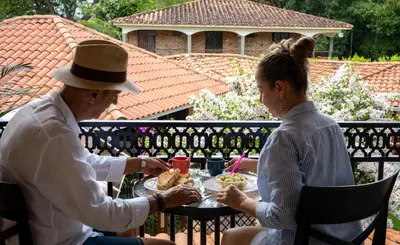 two people sitting at a table eating food at HOTEL PORTAL DE VITERBO Y RESTAURANTE LA FONDA in Viterbo