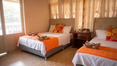 a bedroom with two beds and a window at HOTEL PORTAL DE VITERBO Y RESTAURANTE LA FONDA in Viterbo