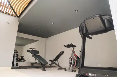 a gym with treadmills and bikes in a room at Hotel Dix in Medellín