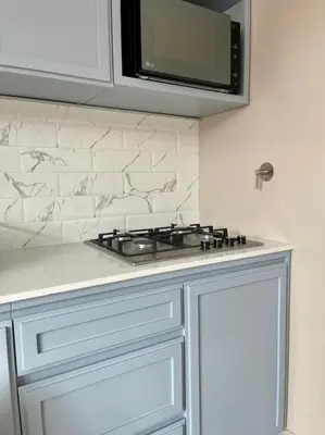 a kitchen with a stove and a microwave at Hotel Dix in Medellín