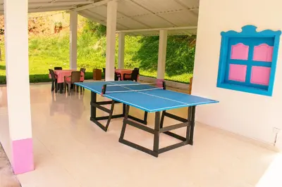 a ping pong table in the middle of a patio at Hotel Jardín Del Río in El Bosque