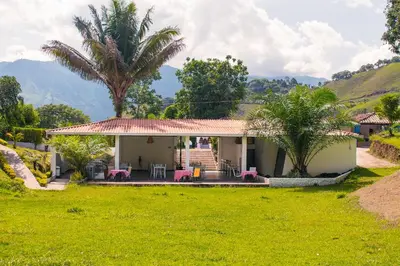 a house with a palm tree and a yard at Hotel Jardín Del Río in El Bosque