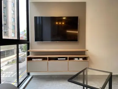 a living room with a television on a wall at Ganesh by Wynwood House in Medellín