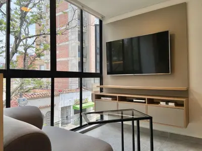 a living room with a flat screen tv on a wall at Ganesh by Wynwood House in Medellín
