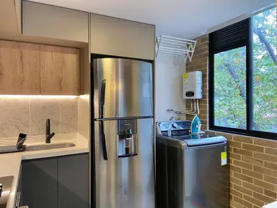 a kitchen with a stainless steel refrigerator and a sink at Ganesh by Wynwood House in Medellín