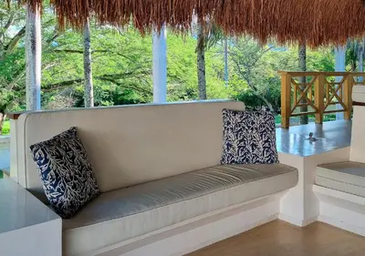a couch with two pillows sitting in a room at HOTEL SANTAFE NATURA - SANTAFE DE ANTIQUIA in Santa Fe de Antioquia