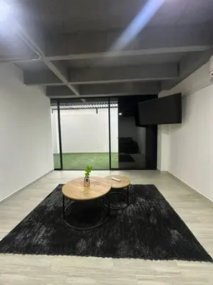 a room with a table and a black rug at Laureles Industry Living 4BR in Medellín
