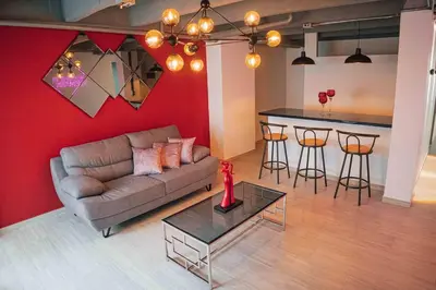 a living room with a couch and a bar at Laureles Industry Living 4BR in Medellín