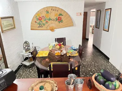 a dining room with a table with chairs and a tableablish at Hostal Monarca in Medellín