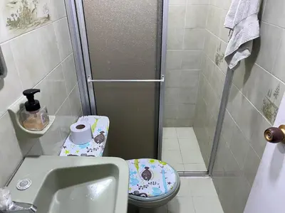 a small bathroom with a shower and a toilet at Hostal Monarca in Medellín