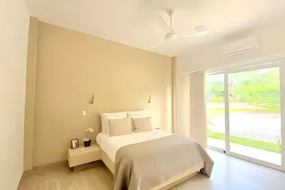 a white bedroom with a bed and a window at Mágica CASA FINCA de lujo piscina privada wi-fi tv in Mariquita