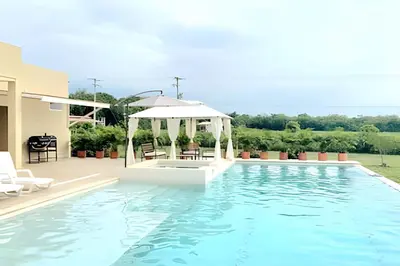 a swimming pool with chairs and a gazebo at Mágica CASA FINCA de lujo piscina privada wi-fi tv in Mariquita