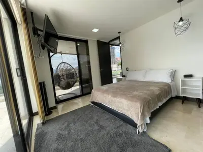 a bedroom with a bed and a large window at 1103 The Overlook of Medellin in El Poblado in Medellín