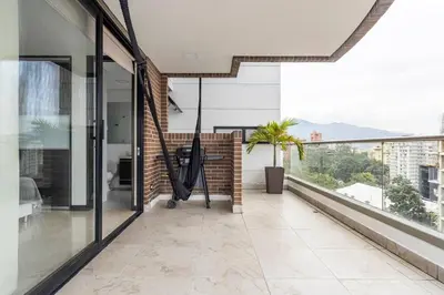 a balcony with glass doors and a view at 1103 The Overlook of Medellin in El Poblado in Medellín