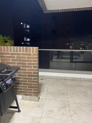 a balcony with a brick wall and a view of a city at 1103 The Overlook of Medellin in El Poblado in Medellín