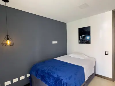 a bedroom with a bed with a blue blanket at 1201 Luxury Excelente ubicación in Medellín