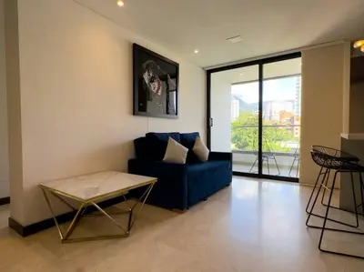 a living room with a blue couch and a table at 1201 Luxury Excelente ubicación in Medellín