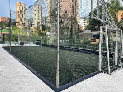a tennis court with a net in a city at 1201 Luxury Excelente ubicación in Medellín