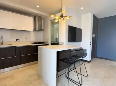 a kitchen with a counter and a bar with a chair at 1201 Luxury Excelente ubicación in Medellín