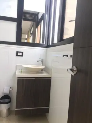 a bathroom with a sink and a mirror at 2004 El Poblado cute and cozy apartment in Medellín