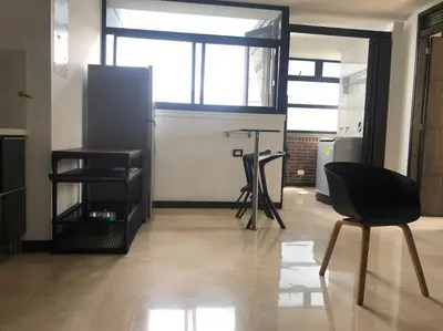 a kitchen with a table and a chair in a room at 2004 El Poblado cute and cozy apartment in Medellín