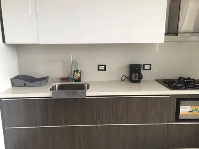 a kitchen with a white counter top and a stove at 2004 El Poblado cute and cozy apartment in Medellín