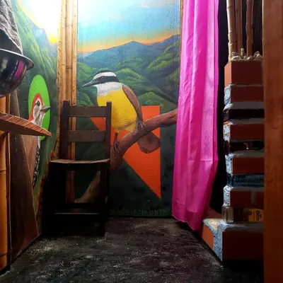a painting of a penguin on a wall in a doorway at Cabaña sol de oriente in Marinilla