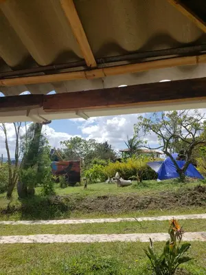a view of a tent and a person in a field at Cabaña sol de oriente in Marinilla