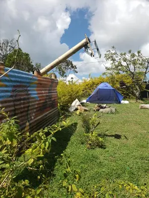a blue tent in a field with a pole at Cabaña sol de oriente in Marinilla