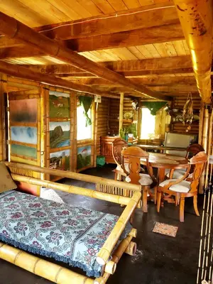 a bedroom with a bed and a table and chairs at Cabaña sol de oriente in Marinilla