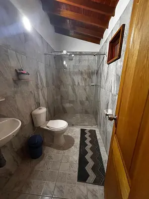 a bathroom with a toilet and a sink at Hotel Olímpica in La Ceja