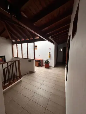 a hallway of a building with a tile floor at Hotel Olímpica in La Ceja