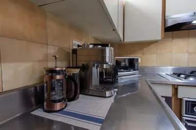 a kitchen with stainless steel counter tops and appliances at CoNomad House - Coliving & Coworking in Medellín