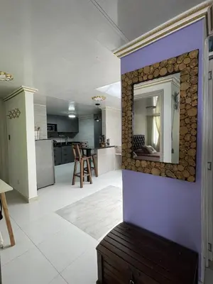 a living room with a mirror on a wall at APARTAMENTO VACACIONAL in Santa Rosa de Cabal