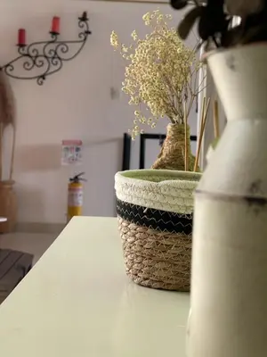 a vase with flowers in it sitting on a table at APARTAMENTO VACACIONAL in Santa Rosa de Cabal