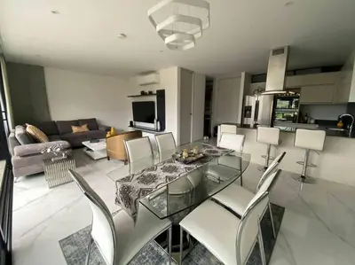 a living room with a glass table and chairs at Luxury apt! Guest friendly! Great location! Jacuzzi, Gym, Security! in Medellín