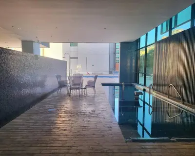 a patio with chairs and a table in a building at Luxury apt! Guest friendly! Great location! Jacuzzi, Gym, Security! in Medellín