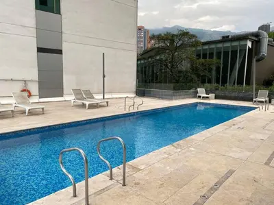 a swimming pool on the side of a building at Luxury apt! Guest friendly! Great location! Jacuzzi, Gym, Security! in Medellín