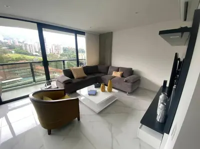 a living room with a couch and a table at Luxury apt! Guest friendly! Great location! Jacuzzi, Gym, Security! in Medellín