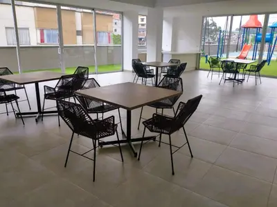 a cafeteria with tables and chairs in a building at BALMORAL in Manizales